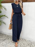 Navy blue sleeveless two-piece outfit with tied waist and wide-leg trousers