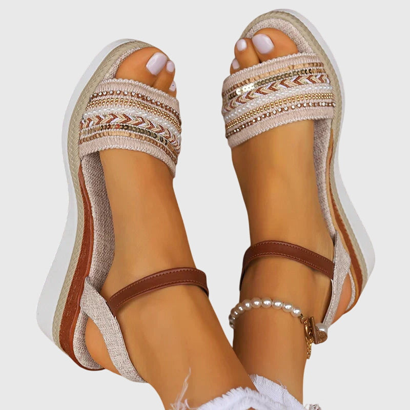 White and brown orthopedic wedge sandals viewed from side with ankle buckle and woven trim