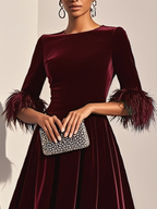 Burgundy velvet midi A-line dress close-up, round neck and feather-trimmed cuffs