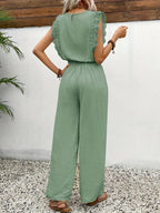Emerald green sleeveless top and wide-leg pants set with lace shoulder ruffles, tie waist