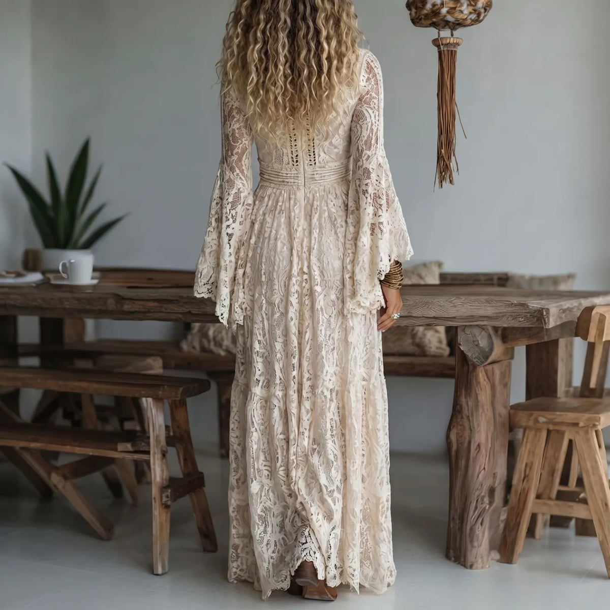 Ivory lace maxi dress from back with long lace sleeves and tiered maxi hem