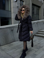 Black puffer coat with taupe fur hood, button closure, and waist tie belt.