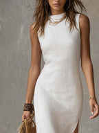 White sleeveless stand-collar midi dress with fitted shape and front slit