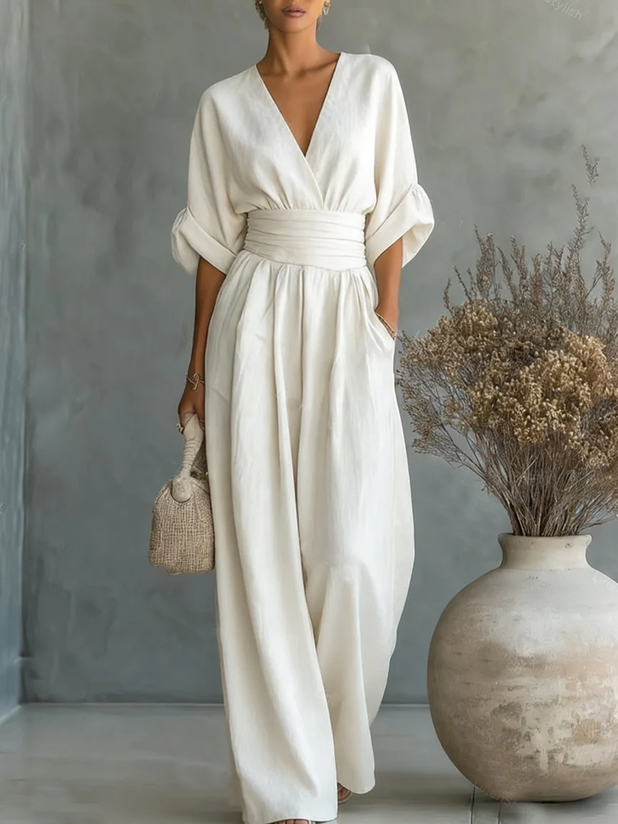 White V-neck high-waist jumpsuit with cinched waist and wide-leg flow, dolman sleeves