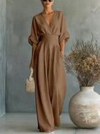 Mocha brown V-neck high-waist jumpsuit with cinched waist and wide-leg flow, dolman sleeves