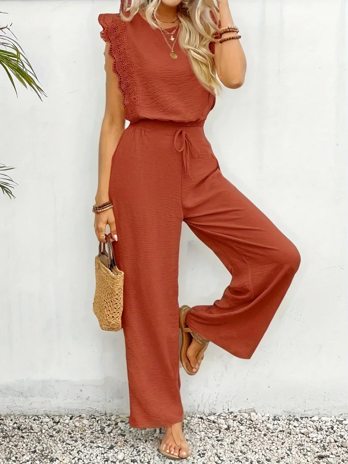 Rust orange sleeveless two-piece set with ruffled shoulder top and wide-leg pants
