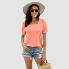 Square-neck blouse in coral pink with puff sleeves and gathered cuffs