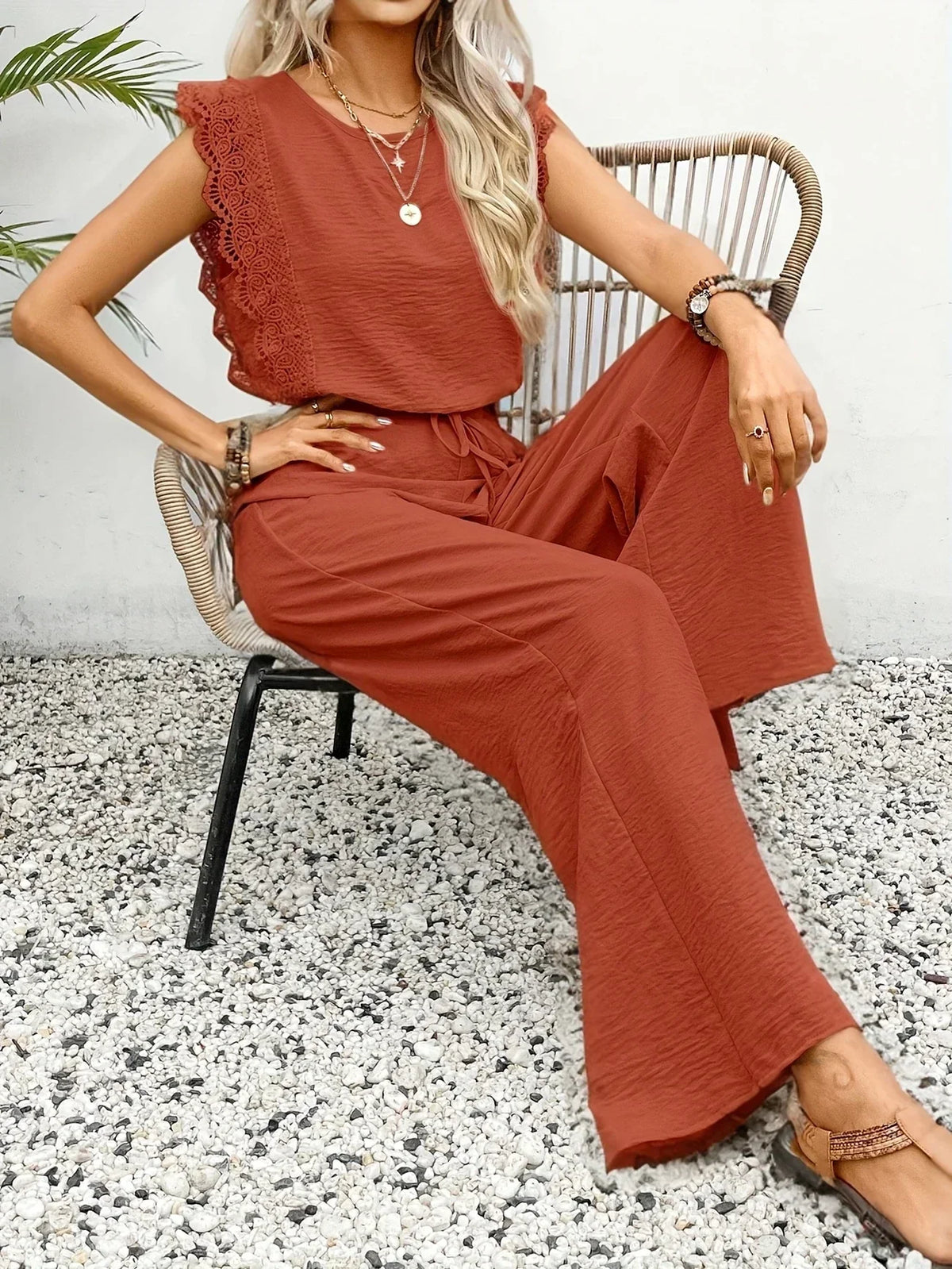 Rust orange two-piece set with sleeveless top and flowy wide-leg pants