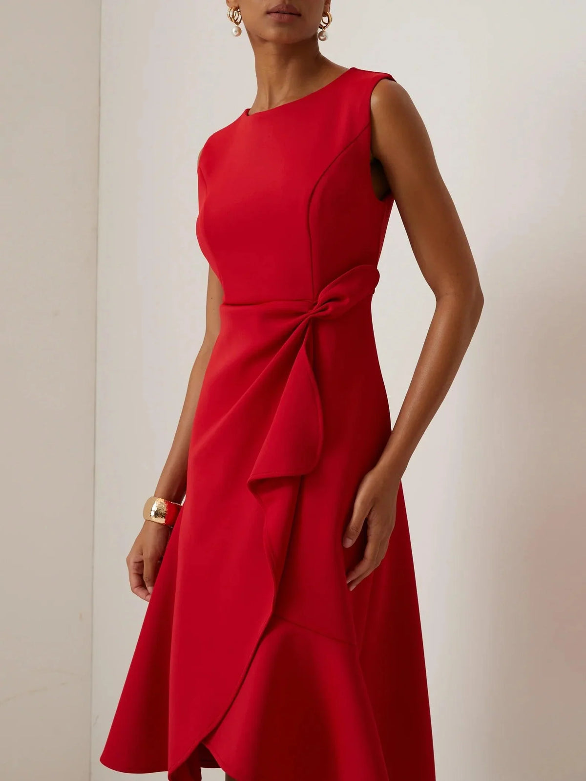 Sleeveless red midi A-line dress with twisted waist detail and scoop neckline