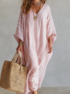 Soft pink striped kaftan dress with V-neck, loose fit, and draped sleeves, front view