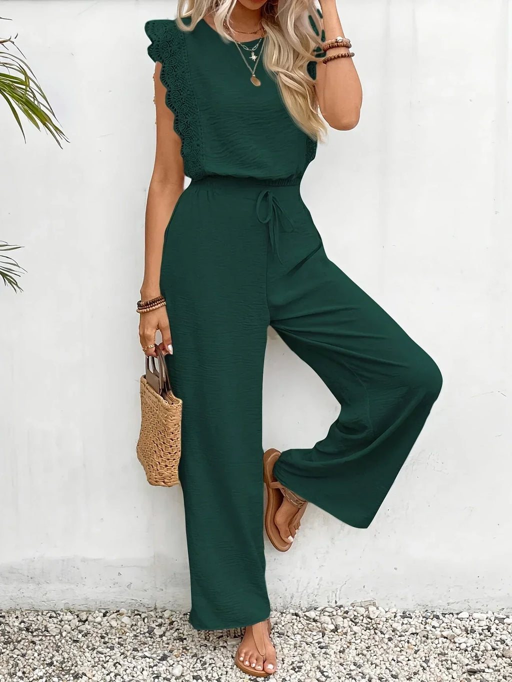 Dark green sleeveless two-piece set with textured ruffle top and wide-leg pants