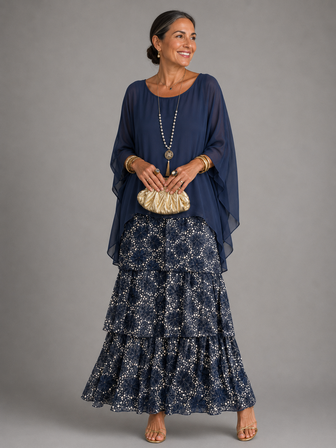 Dark blue tiered maxi dress with ruffle skirt and draped elbow-length sleeves