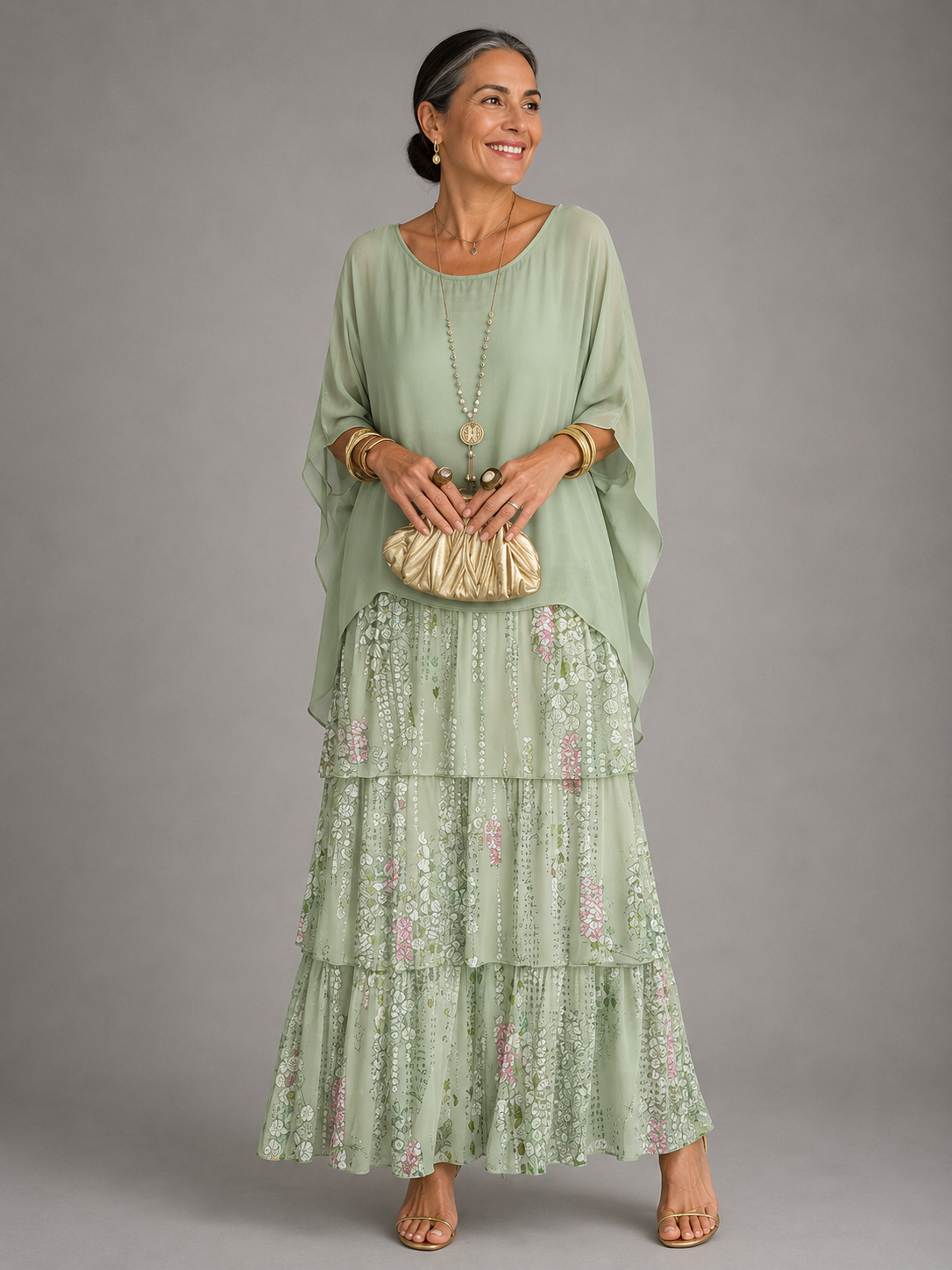 Light green tiered maxi dress with floral ruffle skirt and draped elbow-length sleeves