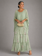 Light green tiered maxi dress with floral ruffle skirt and draped elbow-length sleeves