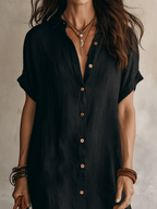 Black linen relaxed midi dress close-up: V-neckline and front buttons detail
