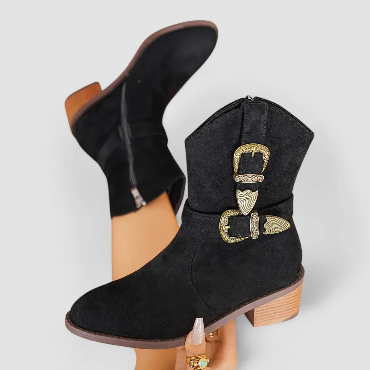 Black suede western boots with decorative side buckle and mid-height block heel.