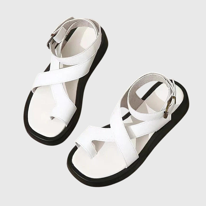 White orthopedic sandals with cross straps and adjustable ankle buckle