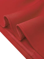 Red fabric close-up showing smooth seam and folded hem edge