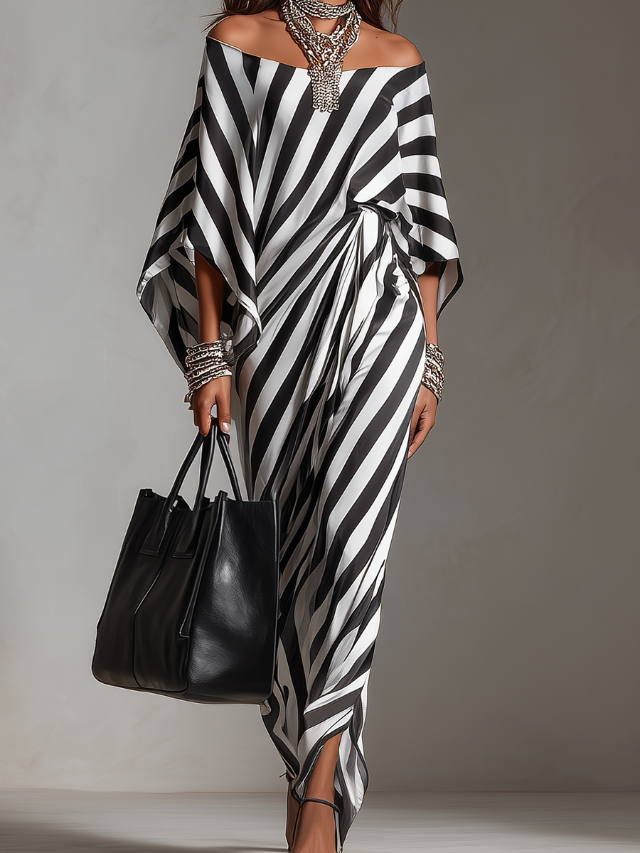 Black-and-white striped off-shoulder maxi dress with asymmetric hem and flowing drape