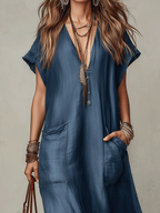 Blue maxi dress with V-neck, button front, and patch pockets