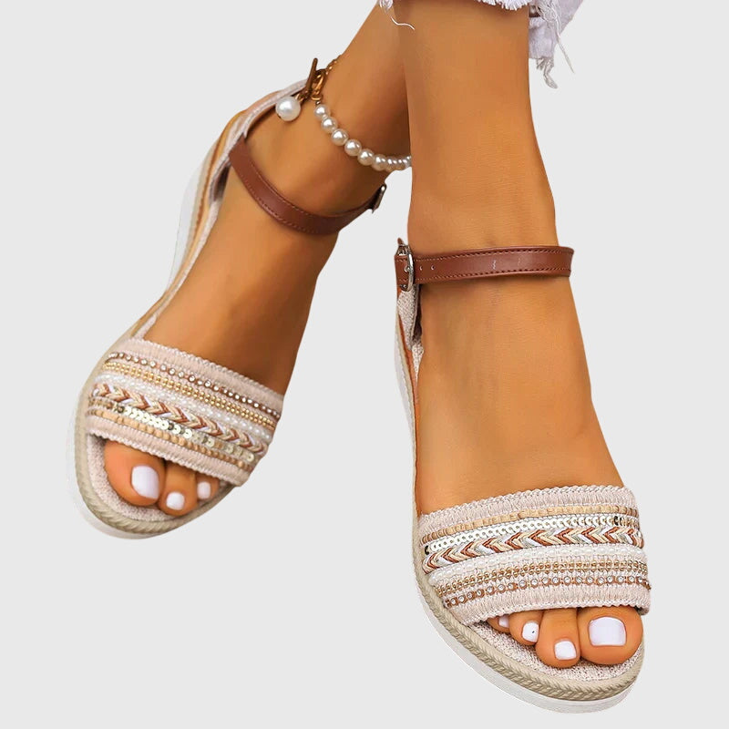 White and brown open-toe wedge sandals with patterned front band and ankle strap buckle