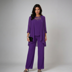 Purple three-piece set with lace-trim yoke top, draped overlay, and wide-leg trousers
