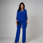 Blue three-piece set with lace neckline, draped top overlay, and wide-leg trousers
