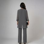 Gray three-piece set back view with draped jacket overlay and wide-leg trousers