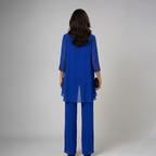 Blue three-piece set back view with draped tunic overlay and wide-leg trousers