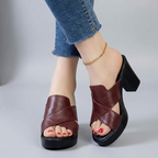 Burgundy orthopedic sandals with crisscross straps and black platform block heel.