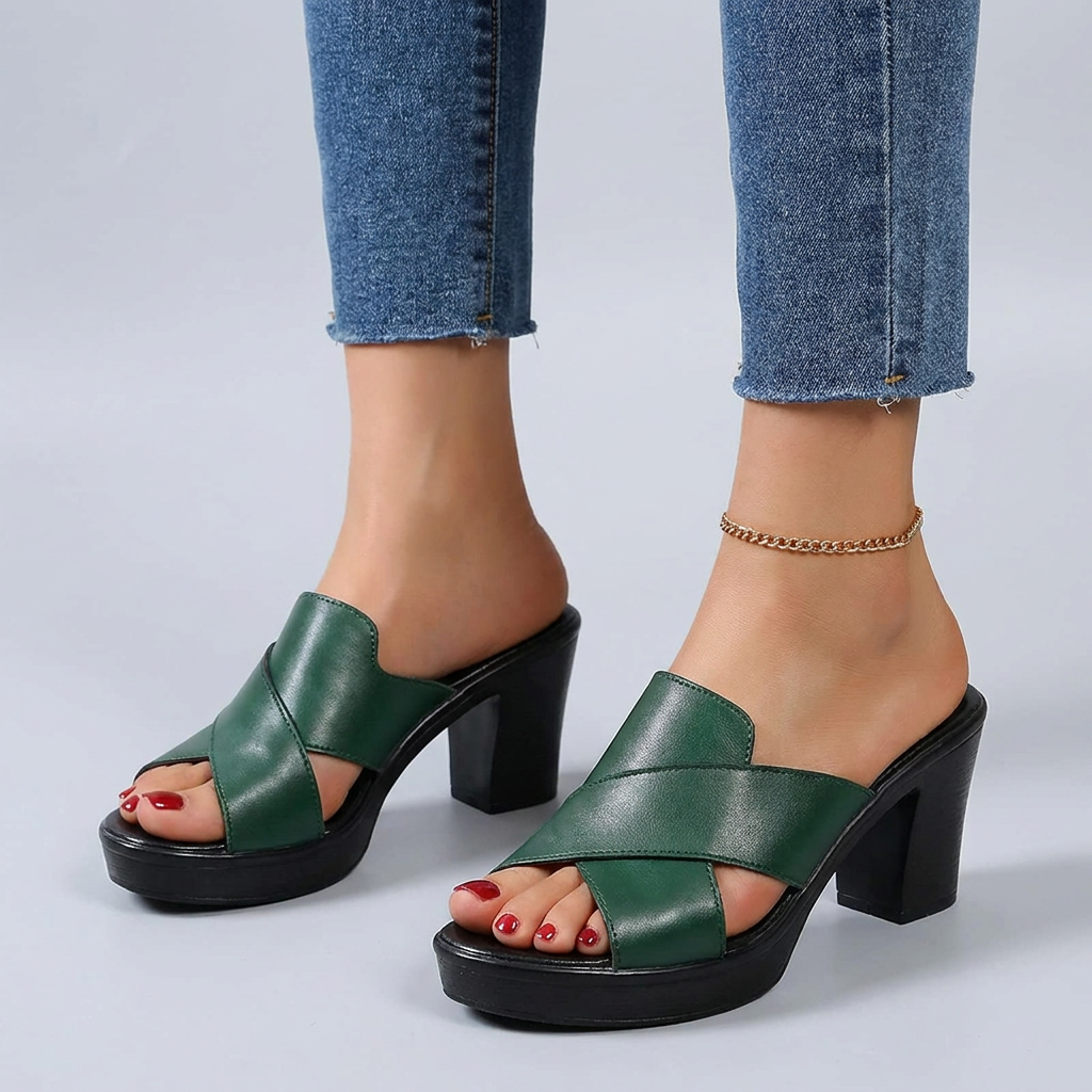 Green orthopedic sandals, side view with wide cross straps and block heel.
