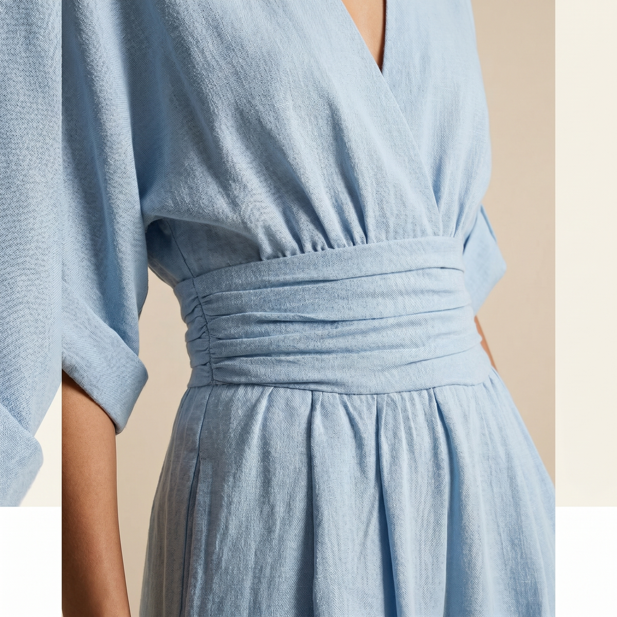 Light blue wrap-style v-neck jumpsuit with ruched elastic high waist and gathered skirt