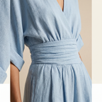 Light blue wrap-style v-neck jumpsuit with ruched elastic high waist and gathered skirt