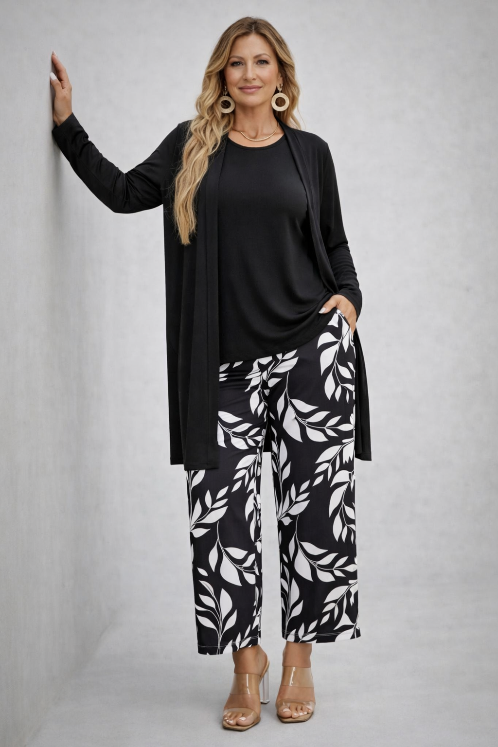 Black 3-piece outfit set with long cardigan, black top, and leaf-print trousers