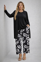 Black 3-piece outfit set with long cardigan, black top, and leaf-print trousers