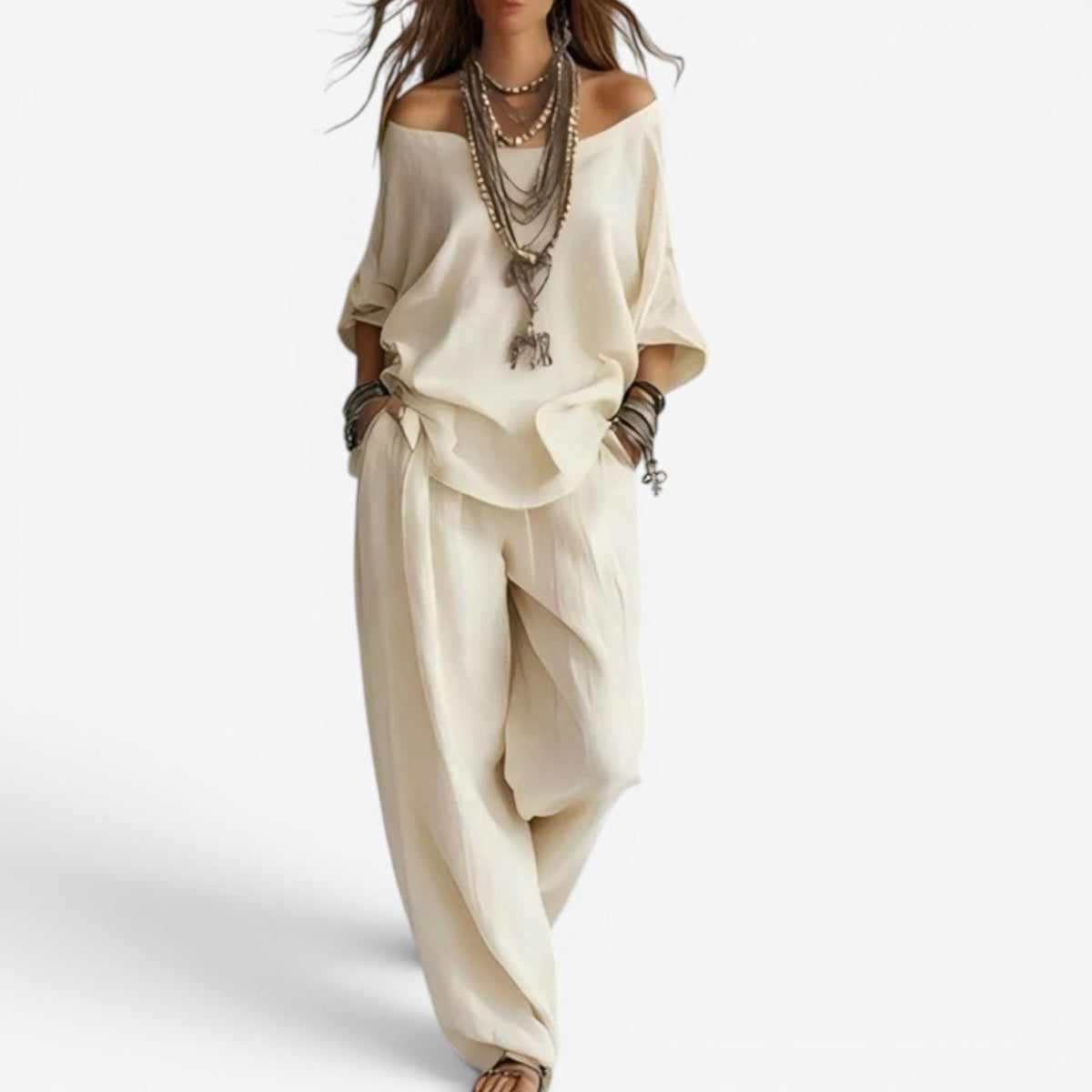 White off-shoulder blouse and draped pants set, loose draped silhouette