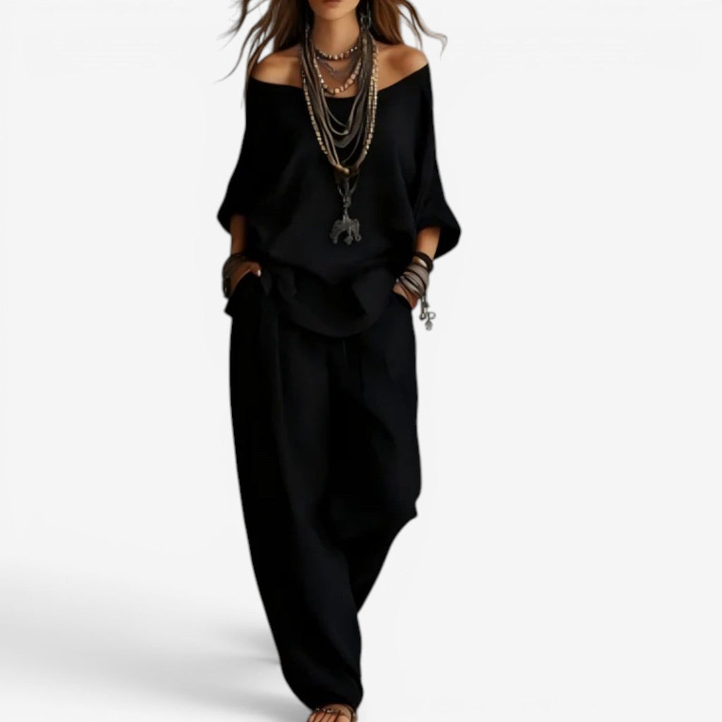 Black off-shoulder blouse and draped pants set, long loose sleeves