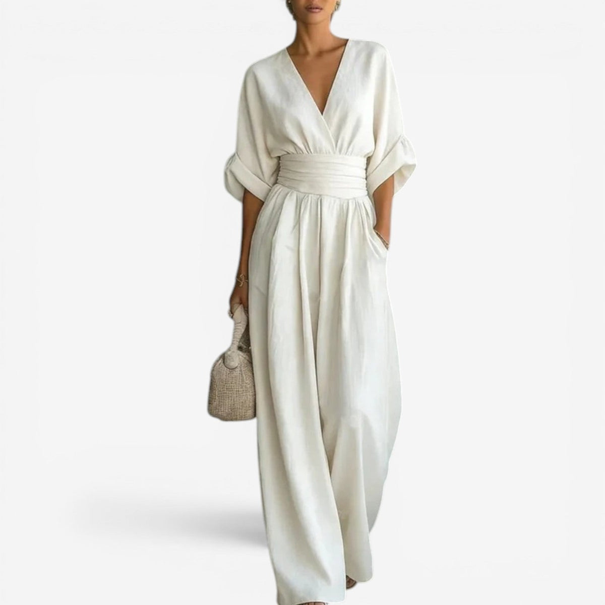 White wrap V-neck jumpsuit with cinched waist and flowing wide-leg legs