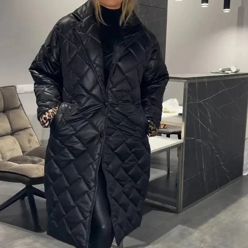 Black longline quilted winter coat with zip front and structured shoulders