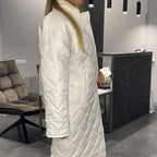 Cream-white quilted long winter coat with zip front and high neck