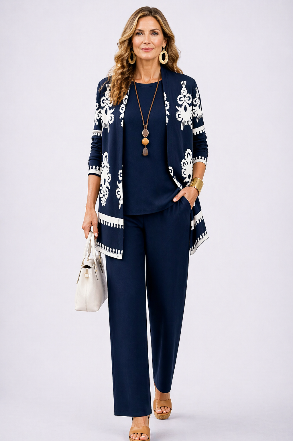 Navy blue 3-piece pants set with white patterned cardigan and matching top