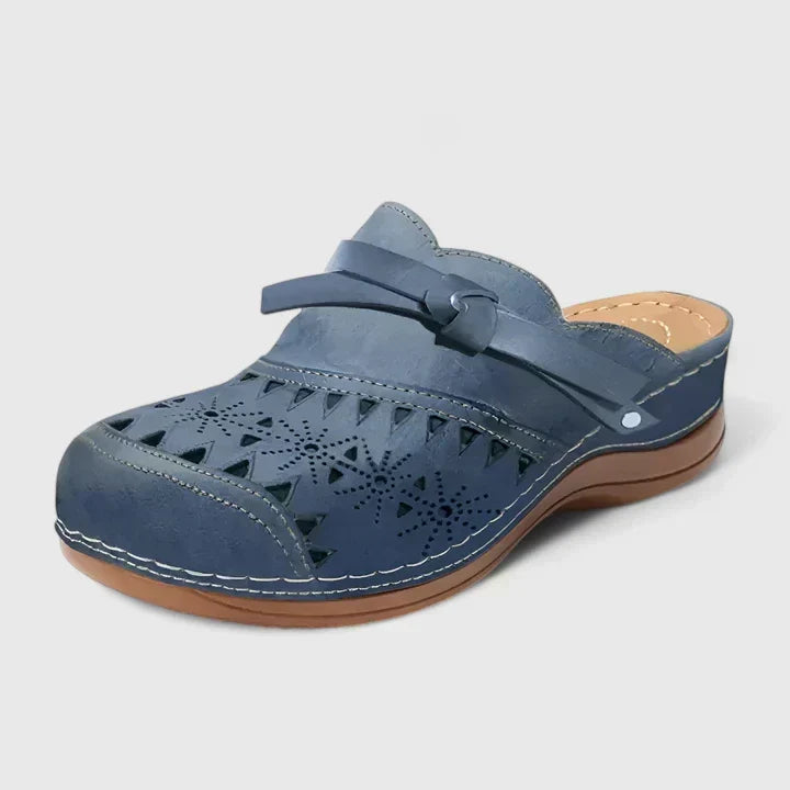 Blue perforated mule sandals with wide strap and cushioned outsole