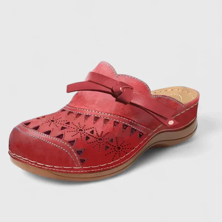 Red perforated mule sandals with wide strap and cushioned outsole