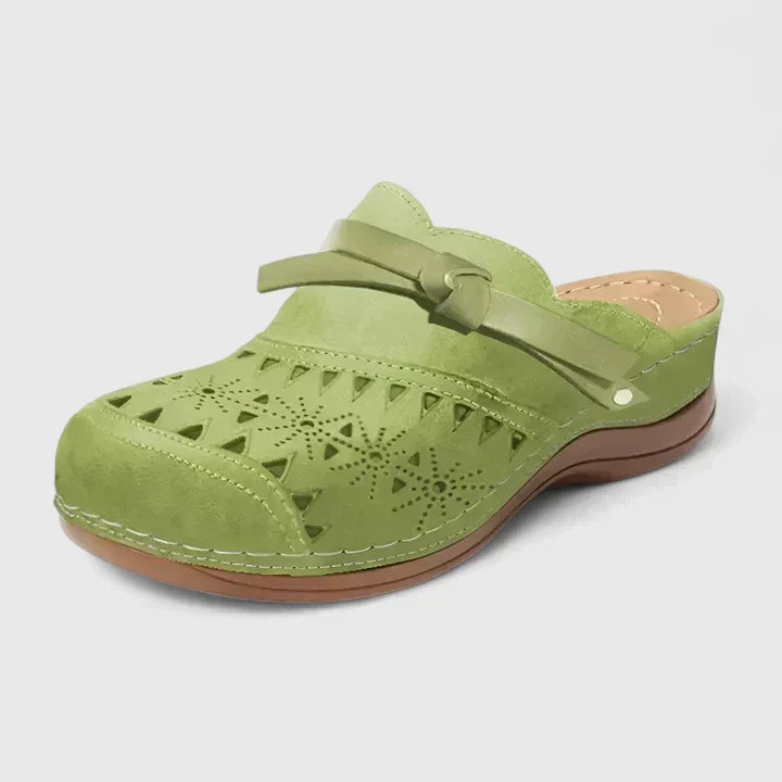 Light green perforated mule sandals with wide strap and cushioned outsole