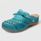 Teal perforated mule sandals with wide strap and cushioned outsole