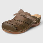 Brown perforated mule sandals with buckle strap and cushioned sole