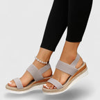 Light gray orthopedic sandals with wide elastic straps and pearl ankle bracelet