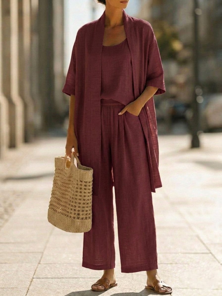 Women's burgundy linen-style set with scoop-neck top, wide-leg pants, and draped cardigan