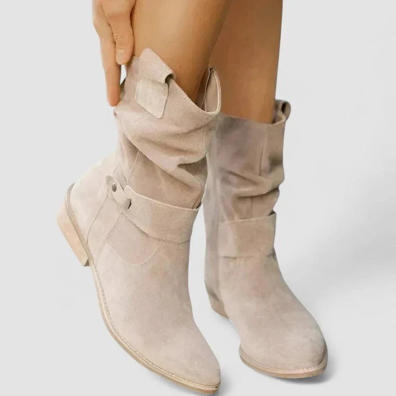 Light beige suede western boots with side zipper and strap across ankle, block heel