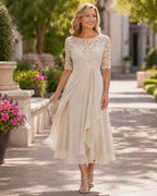 Beige lace bodice midi dress with 3/4 sleeves and flowing chiffon skirt panels